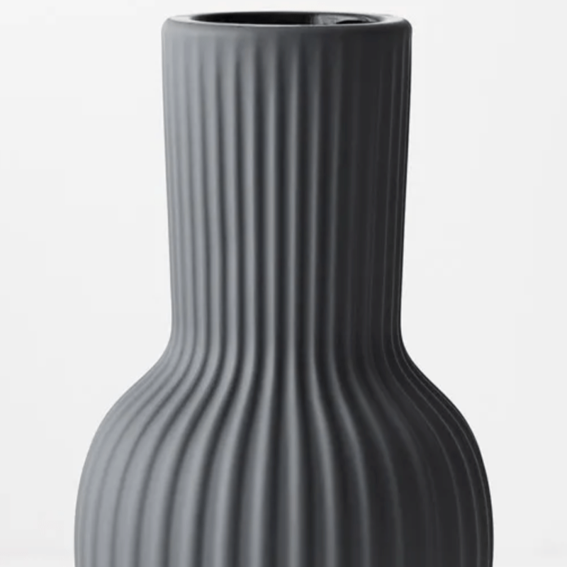 A Floral Interiors Annix Tall Vase - Steel with a ribbed design.