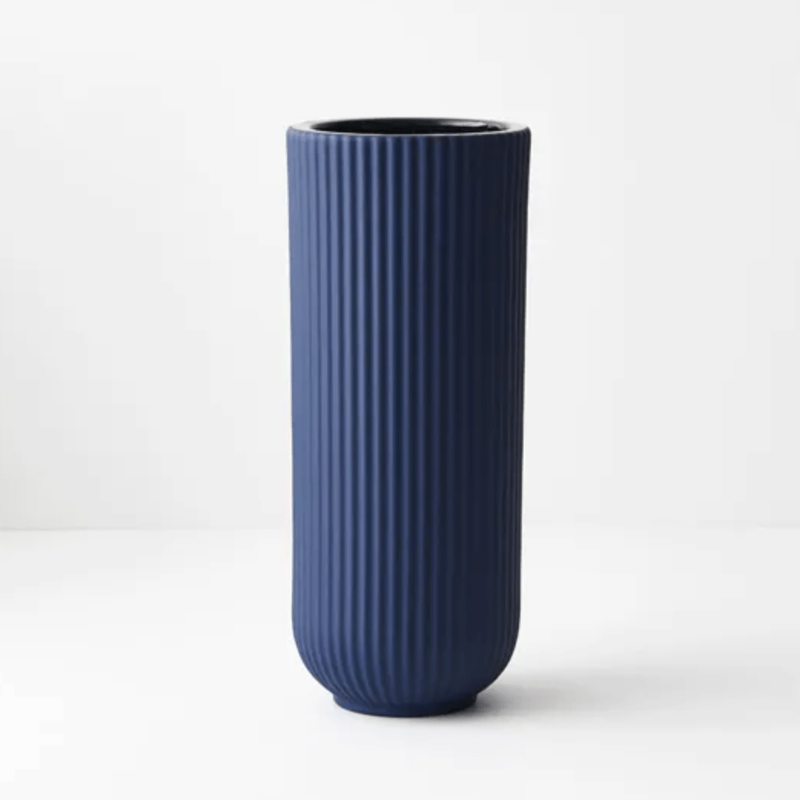 An Annix Vase - Cobalt by Floral Interiors on a white surface.