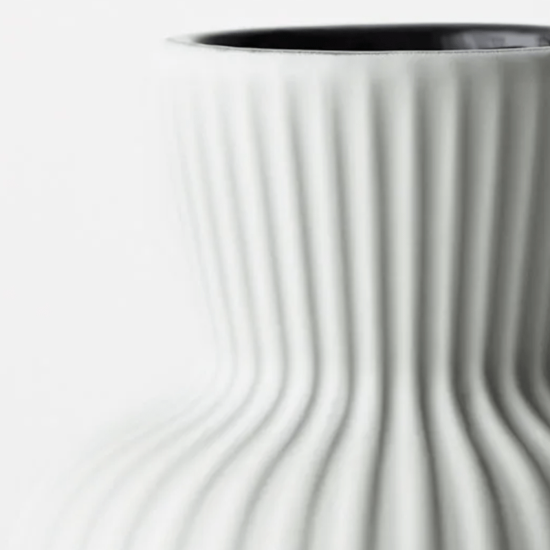Close up of fluted sides of Annix2 vase in light grey