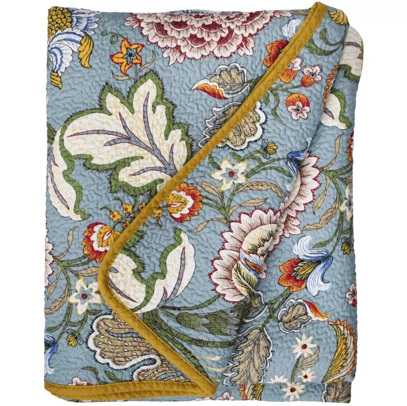 Quilted bedspread with blue, green, orange and white floral pattern