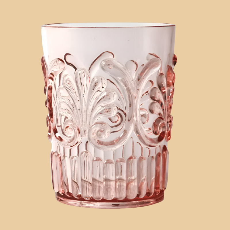 The Flemington Acrylic Tumbler - Pink by Flair Gifts features ornate embossed swirls and floral motifs, perfect for outdoor entertaining. This BPA-free tumbler combines a classical vintage design set against a beige background.