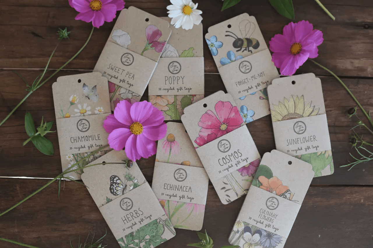 A bunch of Sow n Sow's Chamomile Flower and Butterfly Print gift tags on a wooden table.