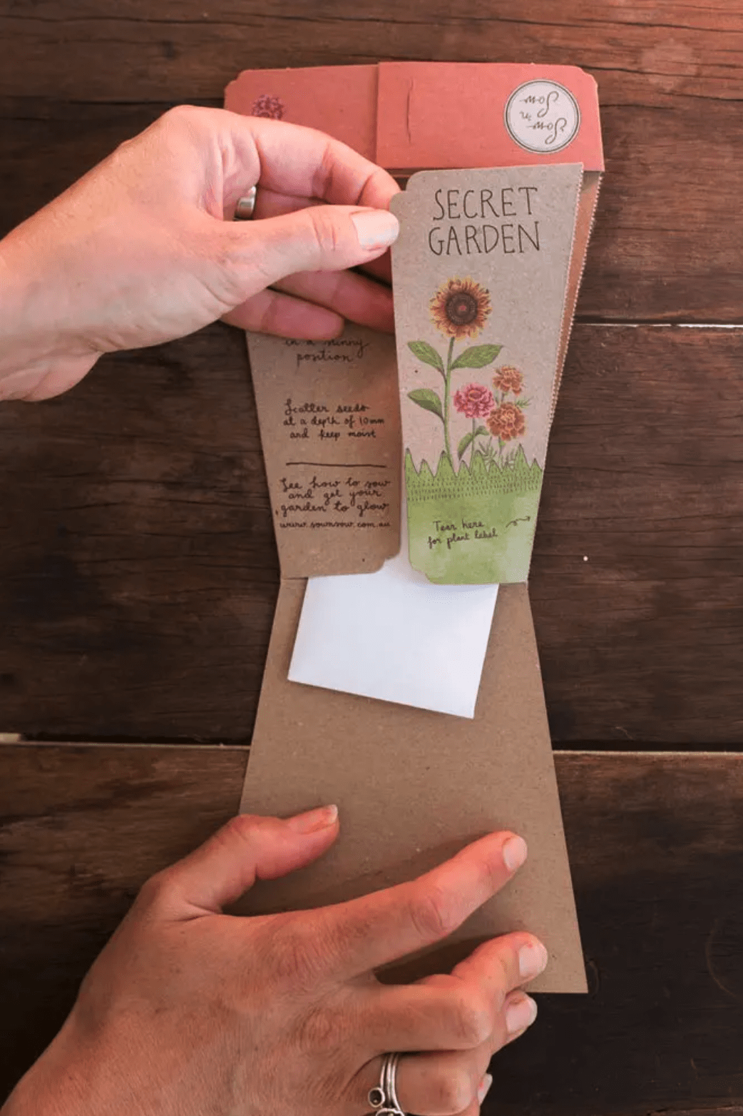 A person opening an envelope with Seeds - Secret Garden from Sow n Sow.