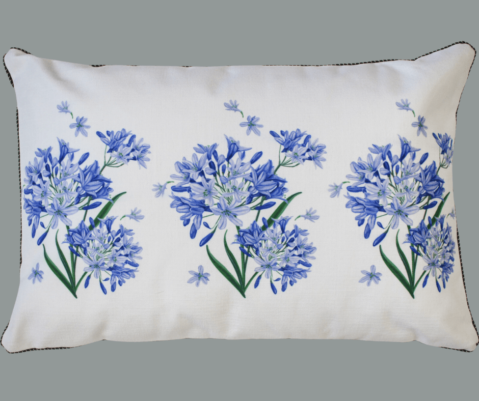 A blue and white Agapanthus Cushion with flowers on it from LaVida.