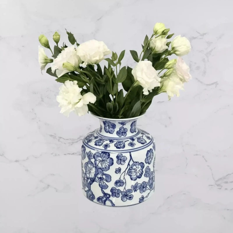 Blue and white floral vase with white flower arrangement