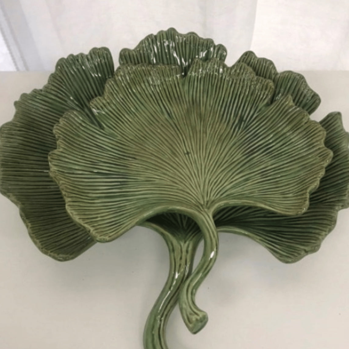 Three green Mediterranean Markets Ginkgo Leaf Plate - Large leaves on a white surface.