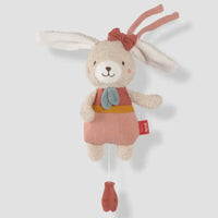 Thumbnail for The Pilbeam FehnNATUR Mini Musical Hare, crafted from organic cotton, features long ears, a red head bow, a pink outfit with blue bow tie, and a red pull-string—an ideal gentle sleeping aid for little ones.