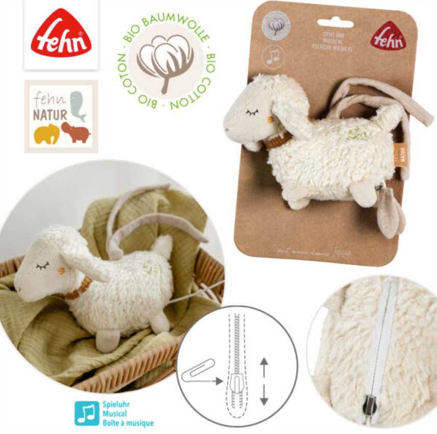 The FehnNATUR Mini Musical Sheep by Pilbeam is an organic cotton plush toy with a Brahms lullaby music box, zipper illustration, and Pilbeam logos on cardboard packaging. One image shows the toy lying in a basket.