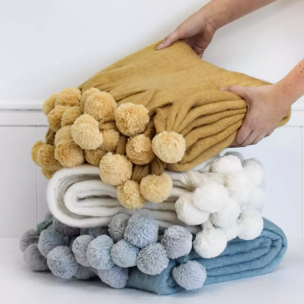How to DIY Pompom Rugs to snuggle by the fireplace