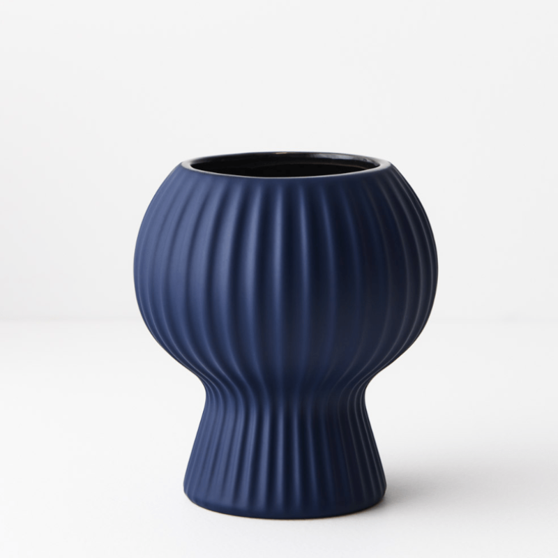 An Annix Pot - Cobalt vase on a white surface.