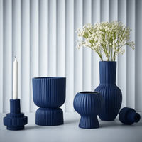 Thumbnail for A group of Floral Interiors Annix Pot - Cobalt vases and a candle on a table.
