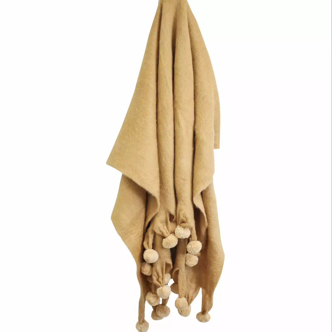 A LaVida Orient Spice throw rug with pom poms hanging on a hanger.