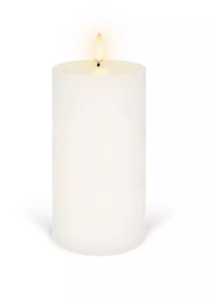 An Enjoy Living Flameless Pillar Candle - 7.8cm x 15.2cm - Nordic White on a white background.