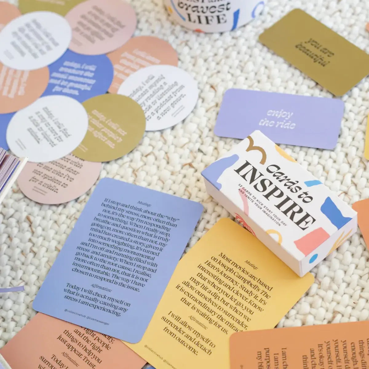 A pile of cards with the Questions to Help You Live Your Best and Bravest Life by Collective Hub on the floor.