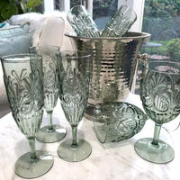 Thumbnail for A set of Flemington Acrylic Champagne Flute - Sage Green wine glasses by Indigo Love on a table.