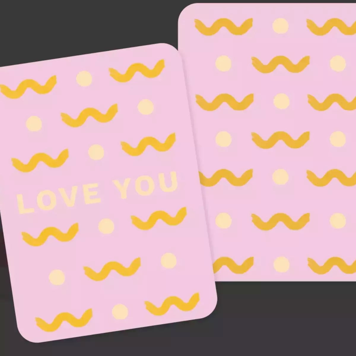 Two bright pink Collective Hub Kindness Cards with the words love you on them.
