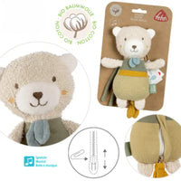 Thumbnail for The Pilbeam FehnNATUR Mini Musical Bear, made of organic cotton in beige and green with a blue scarf, is a plush sleeping aid. Close-up and full-view images show its music box icons, packaging, and zipper detail.