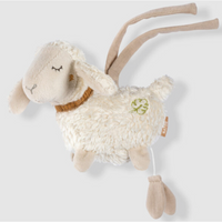 Thumbnail for The Pilbeam FehnNATUR Mini Musical Sheep is a soft, plush toy with closed eyes, a brown collar, green clover embroidery, and beige ties. Made from organic cotton, it plays Brahms lullaby with a pull string for soothing bedtime comfort.