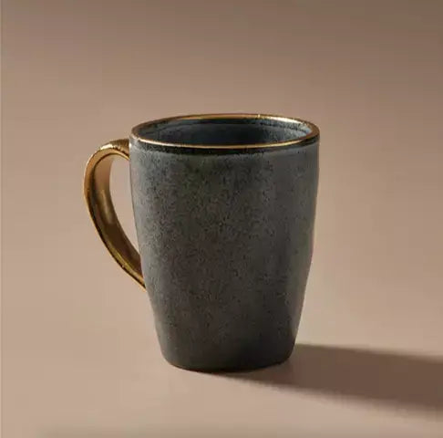 A Senseo Mug - Matt Charcoal by Indigo Love on a beige background.