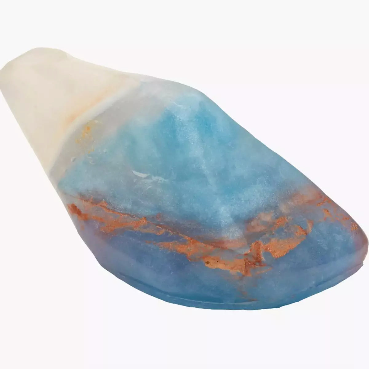 A piece of blue and orange Crystal Soap - OPAL - Coconut + Vanilla by Summer Salt Body on a white background, perfect for skincare or Crystal Soap lovers.