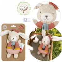 Thumbnail for The FehnNATUR Soft Ring Rattle Hare by Pilbeam is an organic cotton baby toy with long white ears, a pink bow, blue scarf, and a pink-yellow ring-shaped body—perfect for supporting motor skill development. Shown up close and in a basket with cotton plants.