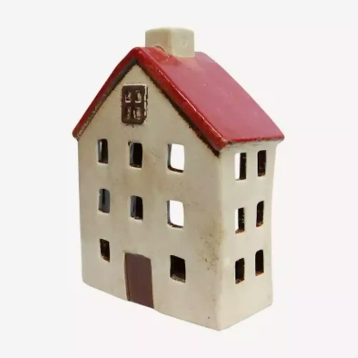A small figurine of a house on a white background, perfect as a French Country Collections Ceramic Building in the Christmas Village Wide Chalet.