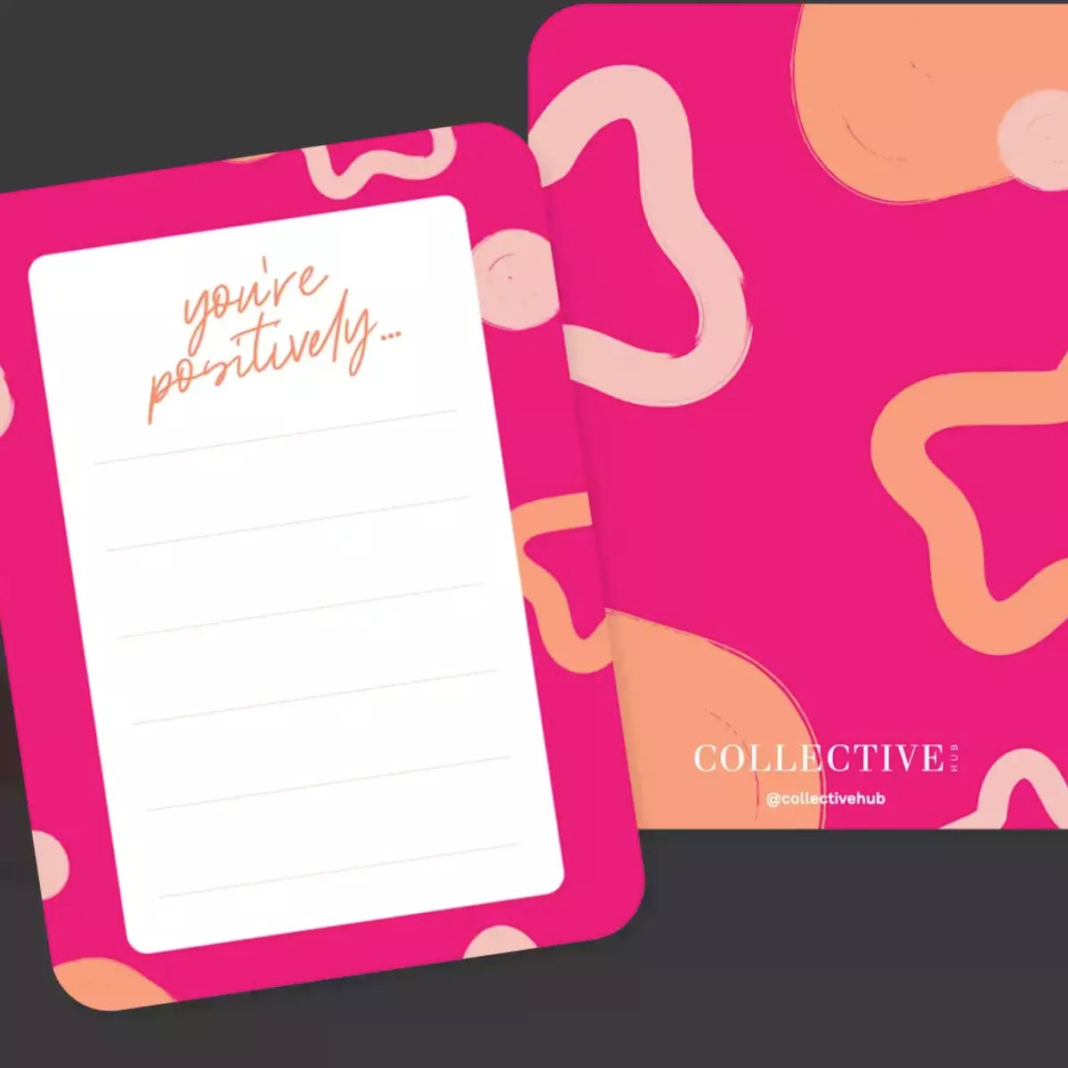 A pink Kindness Cards notepad with the words 'you're positively' on it, designed to brighten someone's day and create a moment of delight by Collective Hub.